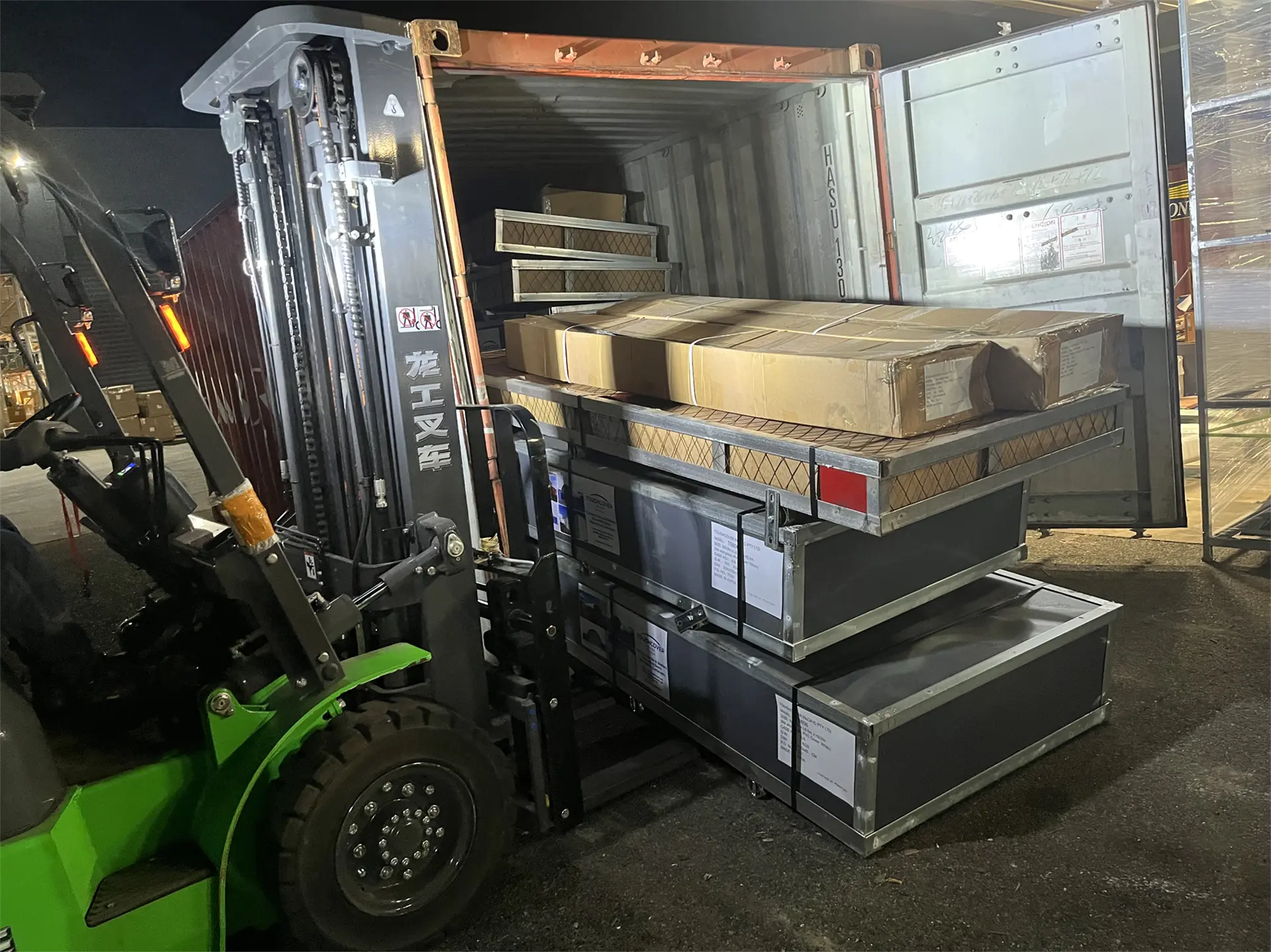 Forklift unloading steel crates from the shipping container Forklift unloading steel crates from the shipping container