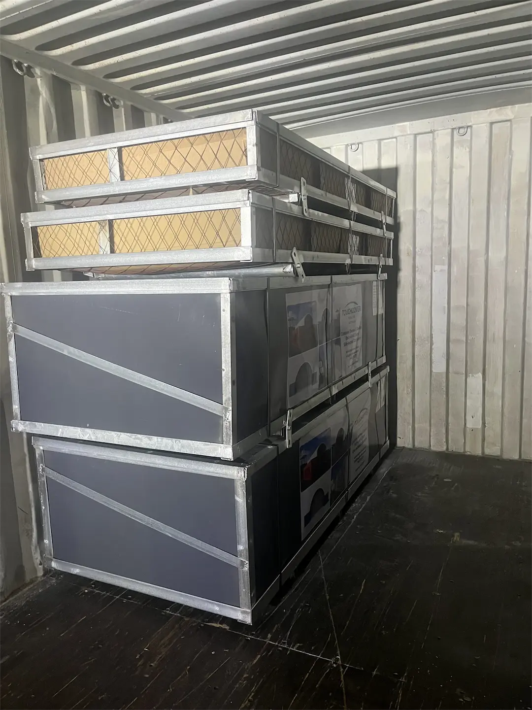 Steel crates inside the shipping container before unloading Steel crates inside the shipping container before unloading